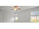 Light and airy bedroom features a ceiling fan, light wood-look floors, and multiple windows, creating a bright and modern living space at 1506 Climbing Dayflower Dr, Ruskin, FL 33570