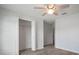 Bright bedroom features wood-look flooring, ceiling fan, closet, and neutral paint at 1506 Climbing Dayflower Dr, Ruskin, FL 33570