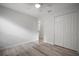 Bright bedroom with wood-look floors, ceiling fan, and closet with bi-fold doors at 1506 Climbing Dayflower Dr, Ruskin, FL 33570