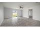 Spacious bedroom with tile floors, a ceiling fan, and sliding glass doors with a view of the backyard at 1506 Climbing Dayflower Dr, Ruskin, FL 33570