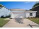 Well-manicured, one-story home with a two-car garage and a driveway, with an easy to maintain front lawn at 1506 Climbing Dayflower Dr, Ruskin, FL 33570