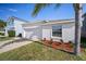 Well-manicured, one-story home with a two-car garage and a driveway, with an easy to maintain front lawn at 1506 Climbing Dayflower Dr, Ruskin, FL 33570