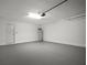 Spacious garage featuring concrete flooring, white walls, and ample room for storage at 1506 Climbing Dayflower Dr, Ruskin, FL 33570