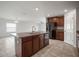 Open-concept kitchen with granite countertops, stainless steel sink and appliances overlooking the adjacent living room at 1506 Climbing Dayflower Dr, Ruskin, FL 33570