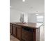 Kitchen island featuring a double sink, granite countertop, and black dishwasher, open to the living area at 1506 Climbing Dayflower Dr, Ruskin, FL 33570