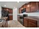 Well-appointed kitchen with stainless steel appliances, ample dark wood cabinetry, and granite countertops at 1506 Climbing Dayflower Dr, Ruskin, FL 33570