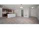 Bright, open living room and kitchen with tile floors, featuring dark wood cabinets and granite countertops at 1506 Climbing Dayflower Dr, Ruskin, FL 33570