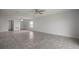 Spacious living room with tile flooring, neutral walls, and a window for natural light at 1506 Climbing Dayflower Dr, Ruskin, FL 33570