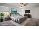Beautifully staged main bedroom features an inviting bed, stylish decor, and light wood-look floors, enhancing the comfort of the space at 1506 Climbing Dayflower Dr, Ruskin, FL 33570