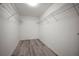 The walk-in closet is complete with wire shelving and light wood-look floors, offering a practical storage solution at 1506 Climbing Dayflower Dr, Ruskin, FL 33570