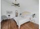 Cozy bedroom with vaulted ceilings, modern fan, wood floors, neutral tones and ample light at 10275 Oasis Palm Dr, Tampa, FL 33615