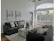 Comfortable living room with soaring ceilings, neutral tones, modern furniture, and lots of light at 10275 Oasis Palm Dr, Tampa, FL 33615