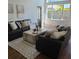 Comfortable living room with soaring ceilings, neutral tones, modern furniture, and lots of light at 10275 Oasis Palm Dr, Tampa, FL 33615