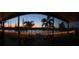 Enjoy this peaceful backyard view of the lake at twilight at 10612 Strawberry Tetra Dr, Riverview, FL 33578