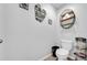 Half bathroom with a toilet, small shelf, and themed decorations at 10612 Strawberry Tetra Dr, Riverview, FL 33578