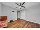 This bright bedroom includes a ceiling fan, hardwood floors, double closet and neutral color scheme at 10612 Strawberry Tetra Dr, Riverview, FL 33578