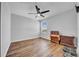 Hardwood floors, a ceiling fan, and plenty of natural light accent this simple, uncluttered bedroom at 10612 Strawberry Tetra Dr, Riverview, FL 33578