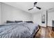 Bright bedroom featuring hardwood floors, ceiling fan, double closet, and neutral colored walls at 10612 Strawberry Tetra Dr, Riverview, FL 33578