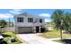 Charming two-story home with a well-maintained lawn, attached two-car garage, and classic design at 10612 Strawberry Tetra Dr, Riverview, FL 33578