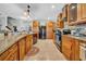 Well-equipped kitchen with wooden cabinetry, tile backsplash, stainless steel appliances, and modern fixtures at 10612 Strawberry Tetra Dr, Riverview, FL 33578