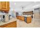 Large kitchen featuring granite countertops, stainless steel appliances, wood cabinetry, and a center island at 10612 Strawberry Tetra Dr, Riverview, FL 33578