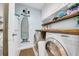 Laundry area with newer washer and dryer, white cabinets, and blue painted walls at 10612 Strawberry Tetra Dr, Riverview, FL 33578