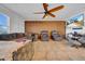 Comfortable living room featuring tile floors, a ceiling fan, and a large sectional sofa at 10612 Strawberry Tetra Dr, Riverview, FL 33578