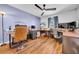 Spacious office with wood floors, a ceiling fan, and a built-in desk at 10612 Strawberry Tetra Dr, Riverview, FL 33578
