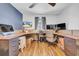 Bright office with wood floors, a ceiling fan, and a built-in desk at 10612 Strawberry Tetra Dr, Riverview, FL 33578