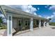 Poolside sitting area with tables, chairs, and a roof for shade at 10612 Strawberry Tetra Dr, Riverview, FL 33578