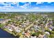Aerial view of property near a lake, surrounded by lush greenery in a suburban neighborhood at 10790 92Nd St, Seminole, FL 33777