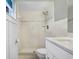 Bathroom with tiled shower, white vanity, and modern fixtures at 10790 92Nd St, Seminole, FL 33777
