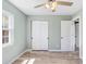 Bedroom with closet, wood-look floors, and large window at 10790 92Nd St, Seminole, FL 33777
