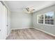 Spacious bedroom with wood-look floors, closet, and ceiling fan at 10790 92Nd St, Seminole, FL 33777