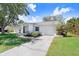 Charming home with a well-manicured lawn and a neatly paved driveway at 10790 92Nd St, Seminole, FL 33777