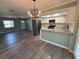 Open floorplan features kitchen with granite counters and stainless appliances; opens to living area at 10790 92Nd St, Seminole, FL 33777