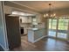 Bright kitchen featuring granite countertops, stainless steel appliances, and access to outdoor dining space at 10790 92Nd St, Seminole, FL 33777