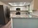 Updated kitchen with granite countertops, white cabinets, and stainless steel appliances at 10790 92Nd St, Seminole, FL 33777