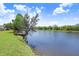 Picturesque lake view with a wooden dock extending into the calm water at 10790 92Nd St, Seminole, FL 33777