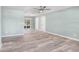 Spacious living room with new flooring, light neutral walls, ceiling fan, and lots of natural light at 10790 92Nd St, Seminole, FL 33777