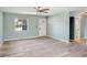 Light-filled living room with neutral paint, ceiling fan, and wood-look floors at 10790 92Nd St, Seminole, FL 33777