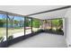 Enclosed patio overlooking green backyard with a view of the lake at 10790 92Nd St, Seminole, FL 33777