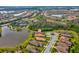 Aerial shot of a residential community featuring single-Gathering homes near a pond and green spaces at 11248 Juglans Dr, Odessa, FL 33556