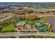 A captivating aerial view showcasing the community's pool, tennis courts, amenities, and lush landscaping at 11248 Juglans Dr, Odessa, FL 33556