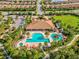 Stunning aerial view highlighting the community's resort-style pool, clubhouse, and lush landscaping in Florida at 11248 Juglans Dr, Odessa, FL 33556