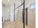 Modern bathroom with a frameless glass shower, neutral tile, and natural light at 11248 Juglans Dr, Odessa, FL 33556