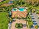 Aerial view of community center, pool, and parking; manicured landscaping throughout the community at 11248 Juglans Dr, Odessa, FL 33556