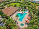Stunning aerial view of a community pool with ample lounge seating surrounded by mature Florida landscaping at 11248 Juglans Dr, Odessa, FL 33556