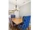 Dining room featuring blue and white decorative chairs, dining table, and chandelier lighting at 11248 Juglans Dr, Odessa, FL 33556