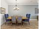 Dining room featuring blue and white decorative chairs, dining table, and chandelier lighting at 11248 Juglans Dr, Odessa, FL 33556